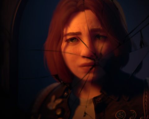 A screenshot from Lost Records: Bloom & Rage, provided to the press. It shows Starr - a teenage girl with chin-length brown hair, light eyes and lost of freckles - from the neck up as a reflection in a mirror that has been broken.